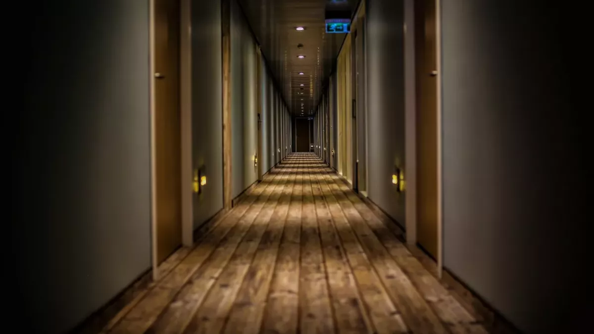 man discovers secret corridor hotel room strange