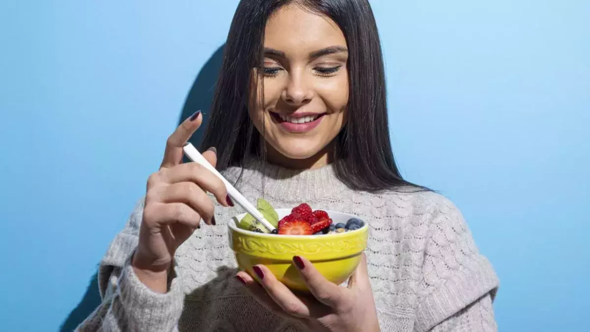 Woman eating looking happy