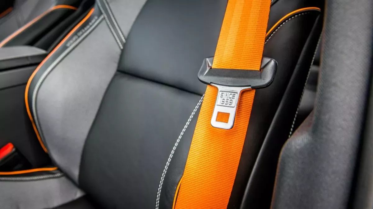 reason mysterious button on car seatbelt