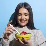 Woman eating looking happy
