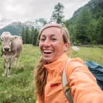 Woman and cow in the Swiss Alps