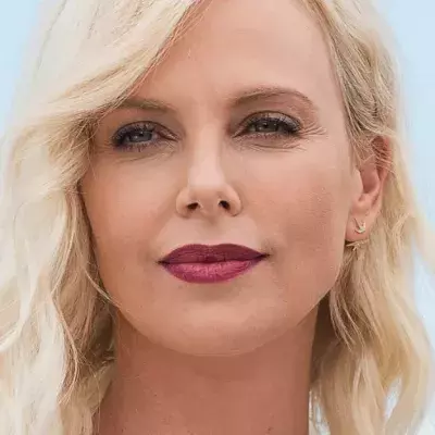 Charlize Theron Decided To Go For A Dary Bold Look With Her Platinum Pixie Cut And Fishnet Dress