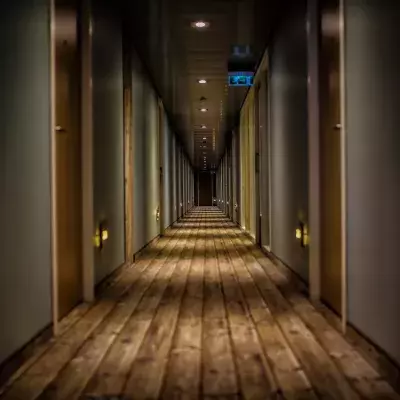 man discovers secret corridor hotel room strange