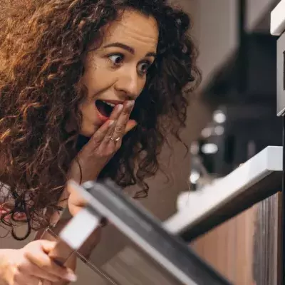 She was baking a cake but she didn't expect to find this in the oven