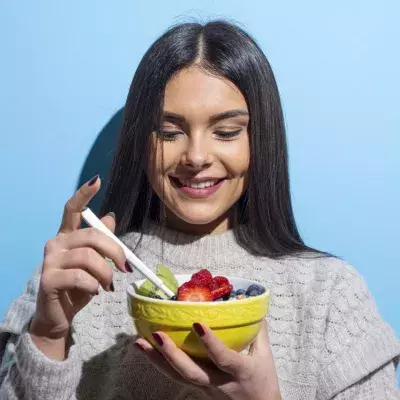 Woman eating looking happy