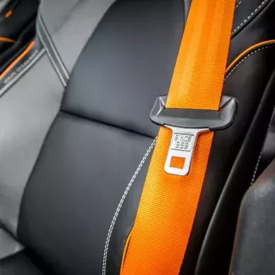 reason mysterious button on car seatbelt