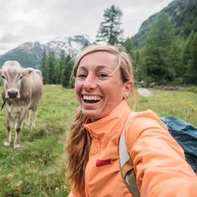 Woman and cow in the Swiss Alps