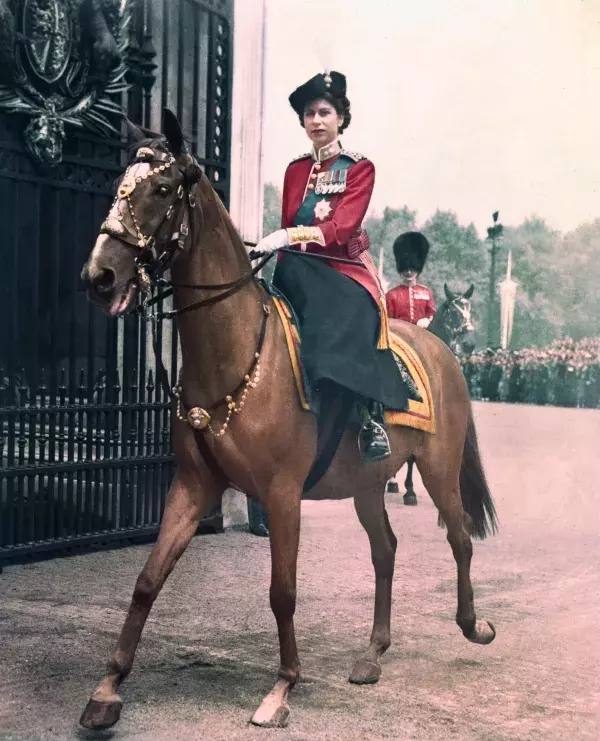 The Queen returning to Buckingham Palace on horseback in 1963 after attending the Trooping the Colour ceremony.