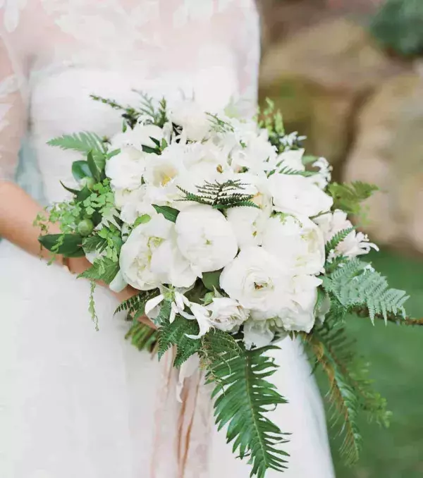 Bridal bouquet: An all white cascading bouquet with a splash of greens