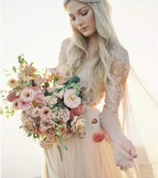 Bridal bouquet: Wild bouquet with an assortment of soft colours like pink, peach, ivory, and white