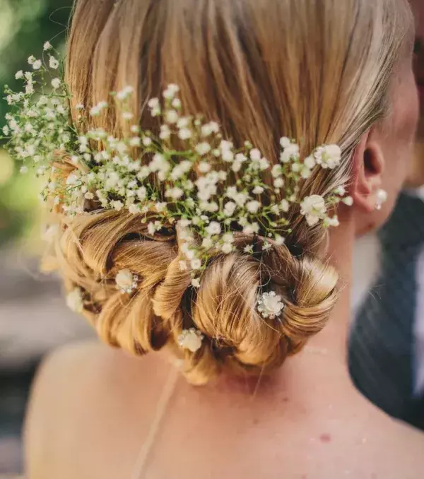 Bridal bun: A low, braided bun, accessorised with flowers