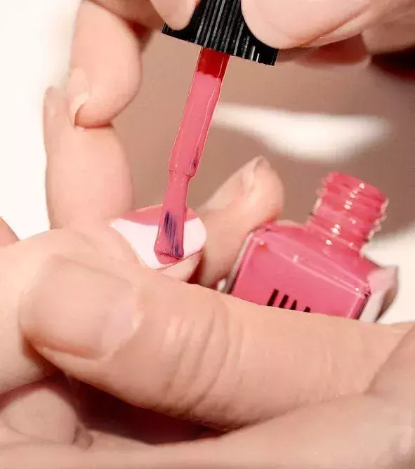Draw a rounded V in the middle of the nail with a darker pink varnish