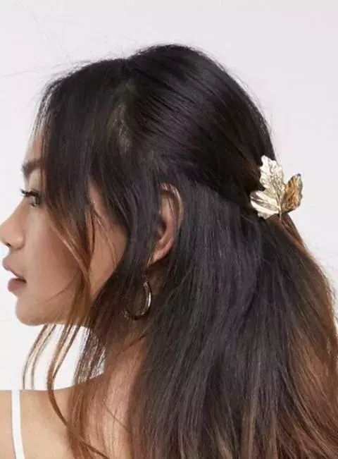 A golden leaf-shaped hair clip