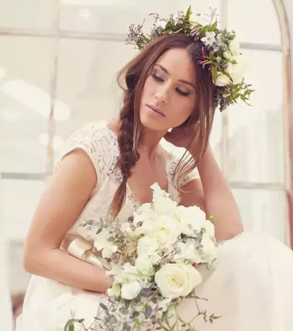 Mid-length wedding hairstyles: Side braid and flower crown
