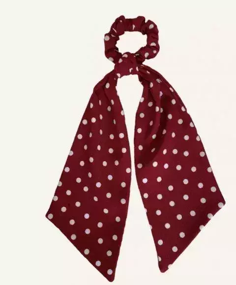 A red scarf scrunchie with white polka dots