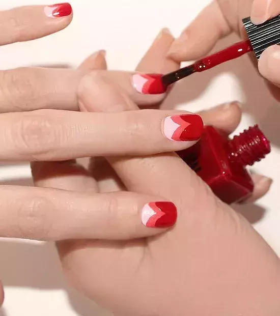 Repeat the same process lower down on the nail with a red varnish