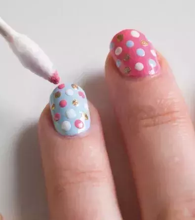 Use a cotton swab to add fun designs on your nails.