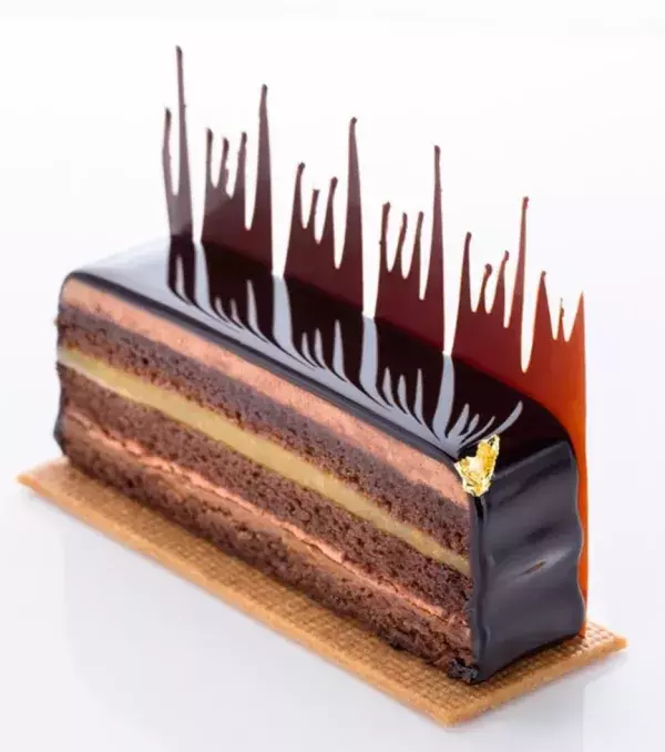 A cake with an explosion of flavours that include dark chocolate, passionfruit, ginger, and praline