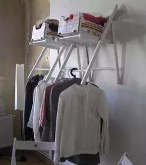 A clothes-rail made out of chairs.
