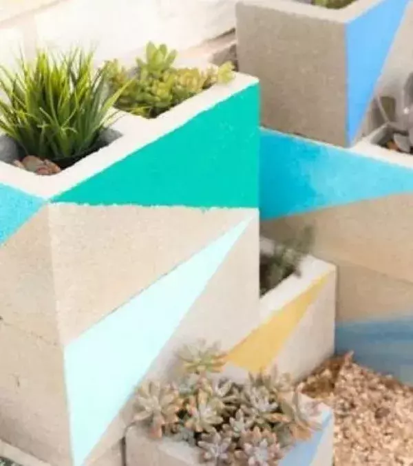 Paint your breeze blocks using bright colors then add various plants for extra creativity!