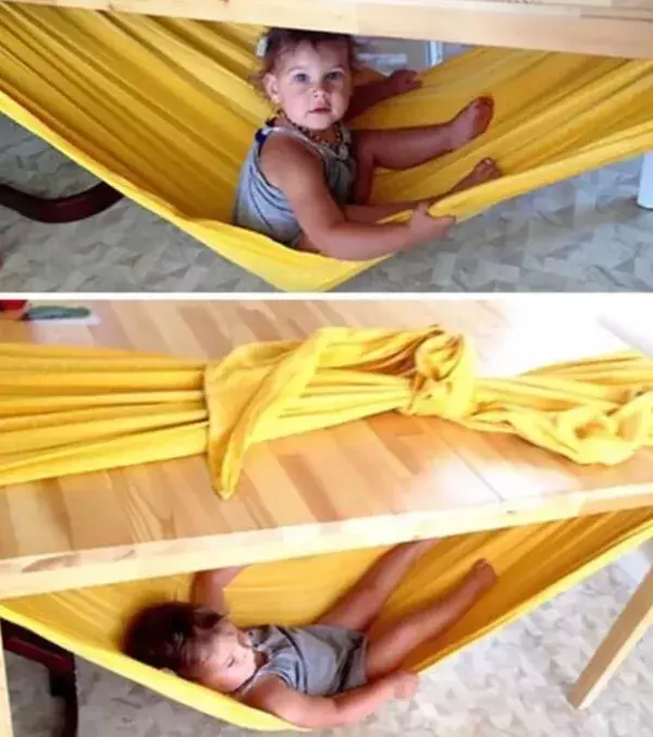 Take a piece of cloth and hang it underneath the dinner table. It's the perfect hammock from your kids to relax in.